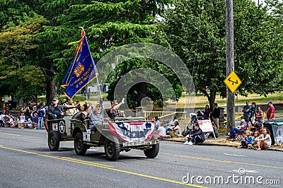 West Seattle Grand Parade, Veterans of Foreign Wars participants riding in a military jeep Editorial Stock Photo