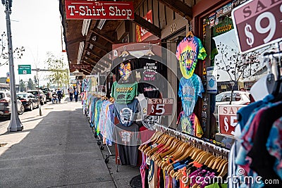 T-shirt store having a sidewalk sale, selling cheap clothing from Yellowstone Editorial Stock Photo