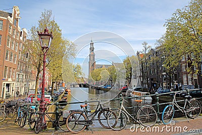 Westerkerk Church clock tower and historic buildings viewed from Reestraat Bridge along Prinsengracht Canal in Amsterdam Stock Photo