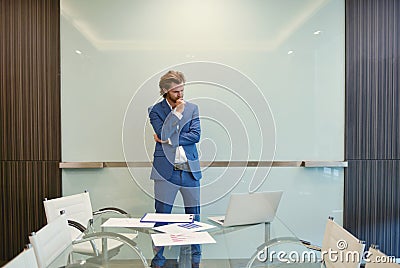 Western businessman presenting a project on blank glass board in Stock Photo