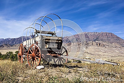 Western covered wood wagon mountains Stock Photo