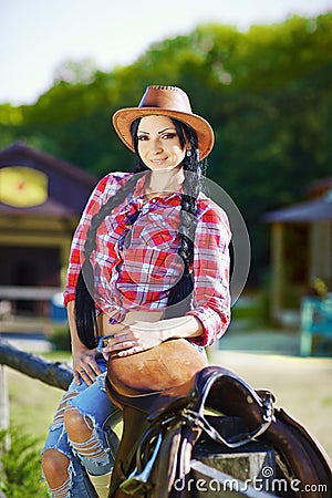 Western,cowboy,cowgirl,rodeo.Cowgirl in western style on the far Stock Photo