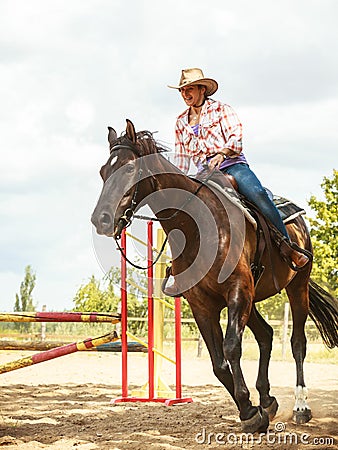 Western cowgirl woman training riding horse. Sport Stock Photo