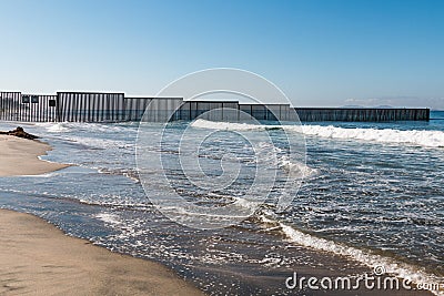 Western End of San Diego-Tijuana International Border Wall in Pacific Ocean Stock Photo