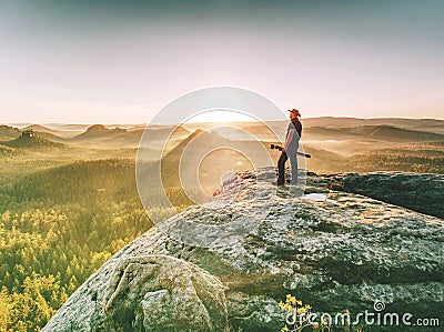 Western fashion photographer set tripod and camera in wild nature Stock Photo