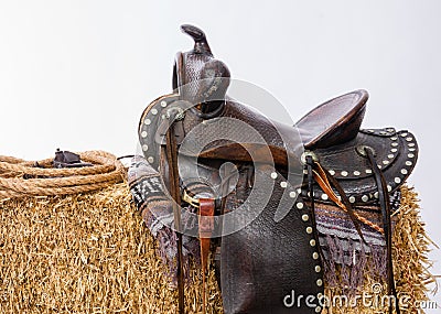 Western Gear Artist's Saddle Tack Gloves Rope Hay Bale Stock Photo