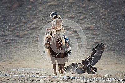 Western Mongolia, Hunting With Golden Eagle. Young Mongolian Girl - Hunter On Horseback Participating In The Golden Eagle Festival Editorial Stock Photo