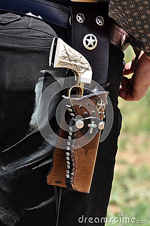 Western pistol gun with ivory handle grip in leather holster gun belt worn by old west cowboy Stock Photo