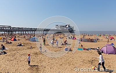 Weston-super-mare beach and pier busy with families on the beautiful May bank holiday weekend Editorial Stock Photo