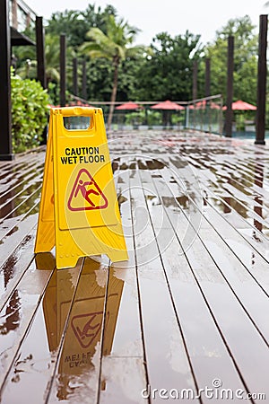 Wet floor warning sign on the floor in hotel corridor Stock Photo