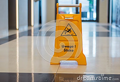 Wet floor warning sign standing in a corridor Stock Photo