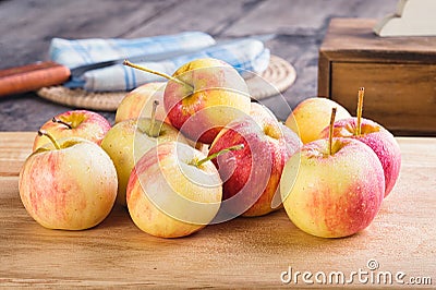 Wet fuji apple on wood chop block and on wood table Stock Photo