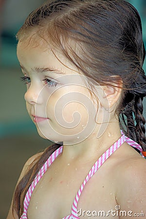 Wet Little girl in her bathing suit Stock Photo