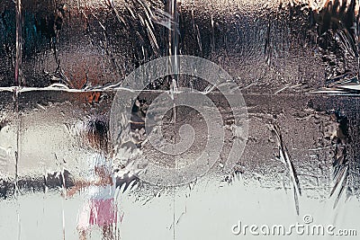 Wet melting frost on the window with blurred background Stock Photo