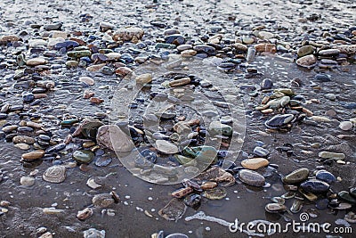 Wet pebbles and sand Stock Photo