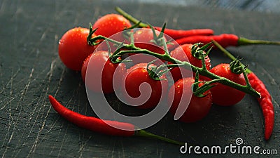 Wet ripe tomatoes and chili pepper Stock Photo