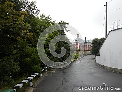 Wet road after rain leads to the church, countryside landscape,calm and silence Stock Photo