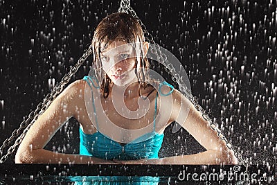 Wet girl leaned on swing with chains Stock Photo