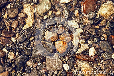 Wet stones in the river, close up. Multicolored rocks in water Stock Photo