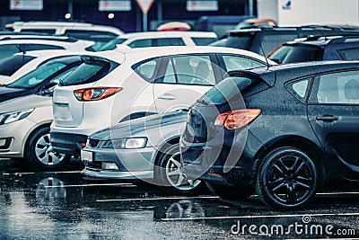 Wet Used Cars on a Parking Lot During Rain Stock Photo