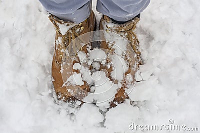 Wet yellow boot in the cold water and snow Stock Photo