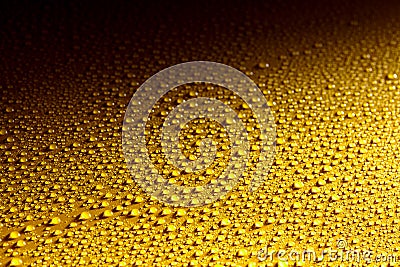 Wet yellow metal surface with glistening drops Stock Photo