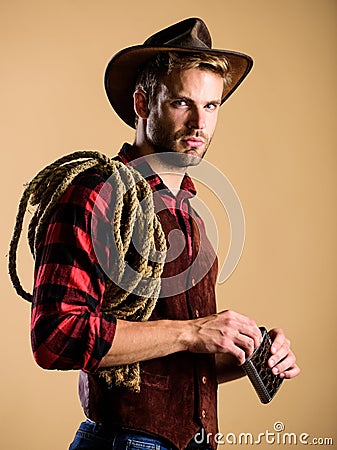 Wet your whistle. wild west rodeo. man in hat drink whiskey. man checkered shirt on ranch. western cowboy portrait Stock Photo