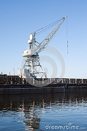 Wharf with hoisting crane Stock Photo