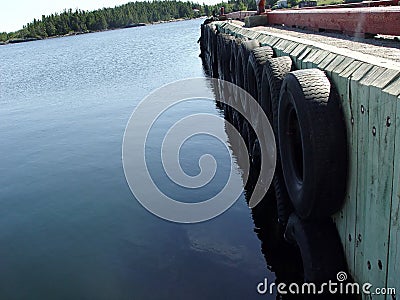Wharf with tires as bumpers Stock Photo