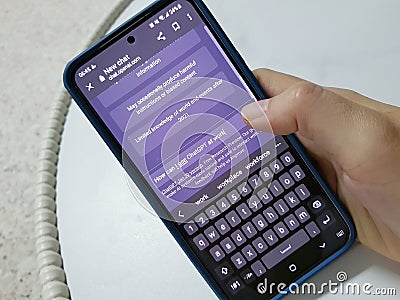 A person typing how can I use ChatGP at work. ChatGPT is an Artificial intelligence chatbot service provided by OpenAI Editorial Stock Photo