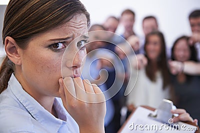 What do I do now. Closeup of an anxious young woman facing the accusatory fingers of her coworkers. Stock Photo