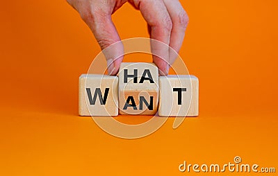 What do you want symbol. Businessman turns cubes and changes the word `want` to `what`. Beautiful orange background, copy spac Stock Photo