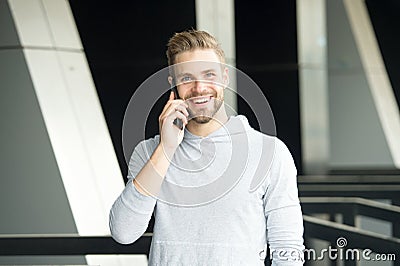 What great news. Man with beard call smartphone urban background. Guy happy smile use smartphone to communicate friends Stock Photo