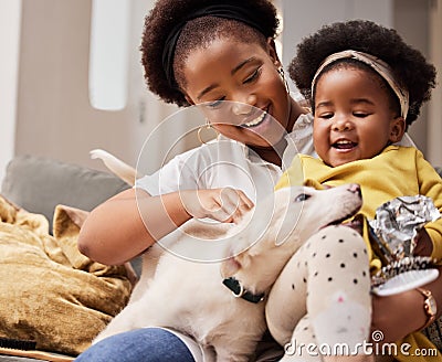 This is what makes life worth it. a young mother and daughter relaxing with their pet at home. Stock Photo
