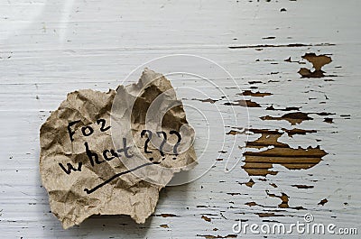 For what Question written by hand on a piece of torn paper Stock Photo