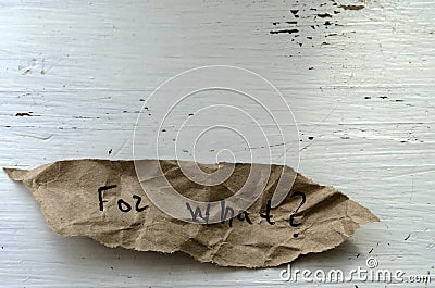 For what Question written by hand on a piece of torn paper Stock Photo