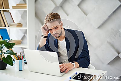 Thoughtful male working in business center Stock Photo