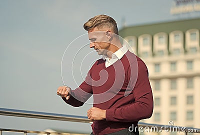 What time is it. Handsome man check time by wrist watch. Observing punctuality. Time management. Timing accuracy Stock Photo