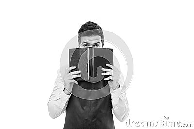 What to cook. Man hipster cook apron reading book about culinary. No idea how cook food. Culinary book concept. Man in Stock Photo