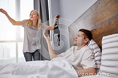 What it is woman with strange bra in hands, man cheated on his wife Stock Photo