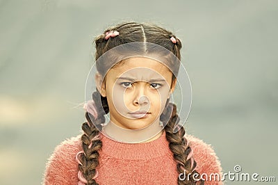 What is wrong. Hairdresser salon. Braided cutie. Little girl with cute braids close up. Kanekalon strand in braids of Stock Photo