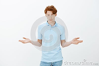 What is your point, cannot understand. Portrait of unaware confused young handsome guy in trendy clothes, raising hands Stock Photo