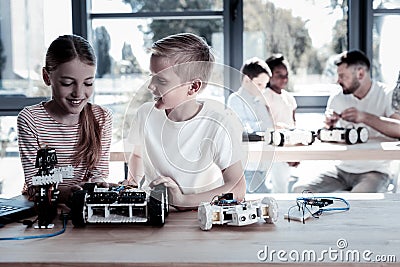 Adorable youngsters talking over new robotic machine Stock Photo