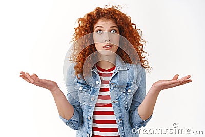 Whats point. Perplexed worried redhead confused young silly girlfriend wide eyes shrugging hands spread sideways puzzled Stock Photo