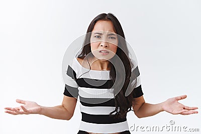 Whats your problem dude. Pissed and angry confused young woman squinting stare with scorn and dismay shrugging, hands Stock Photo