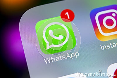 Whatsapp messenger application icon on Apple iPhone X smartphone screen close-up. Whatsapp messenger app icon. Social media icon. Editorial Stock Photo