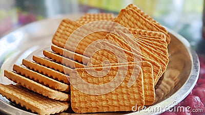 Wheat biscuits in the steel plate with blur background. Indian biscuits popularly known as Chai-biscuit in India Stock Photo