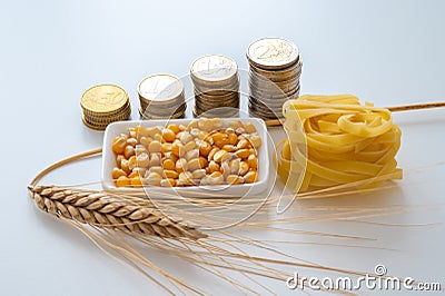 Wheat, corn, pasta and money. Increase in the price of wheat and shortage of corn derived products. Stock Photo