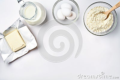 Wheat flour in the glass bowl, cream in a glass jar, butter, chicken eggs - ingredients for the dough, top view Stock Photo