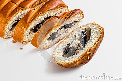 Wheat flour roll with poppy seed filling on a white background Stock Photo